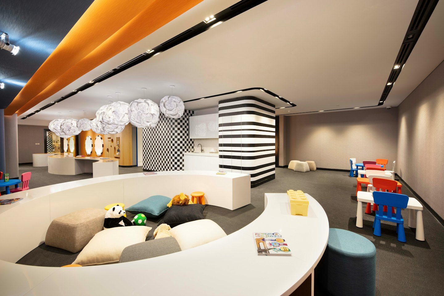 Children's colorful play area with tables and seating.