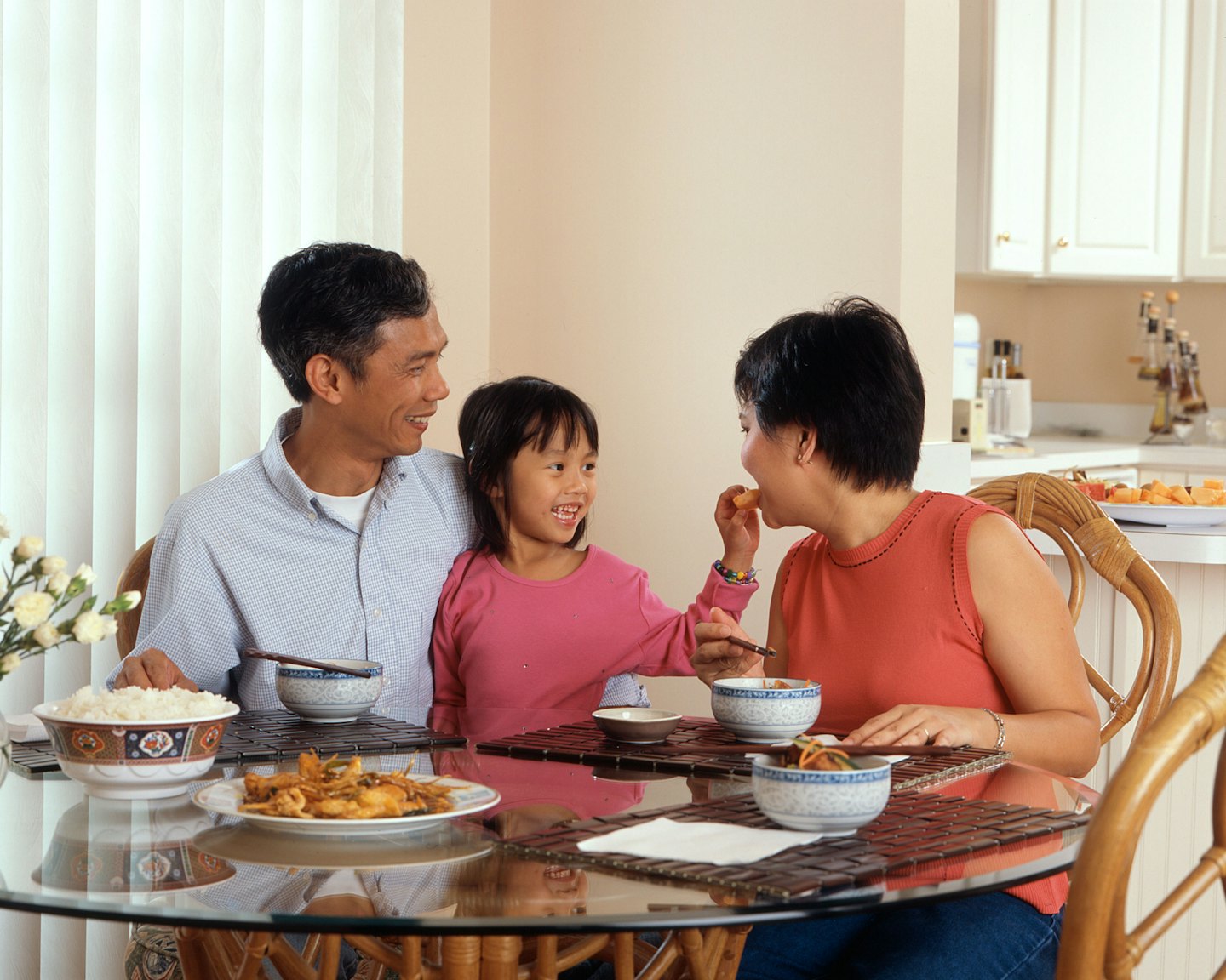 Family shares a happy meal together at a dining table.
