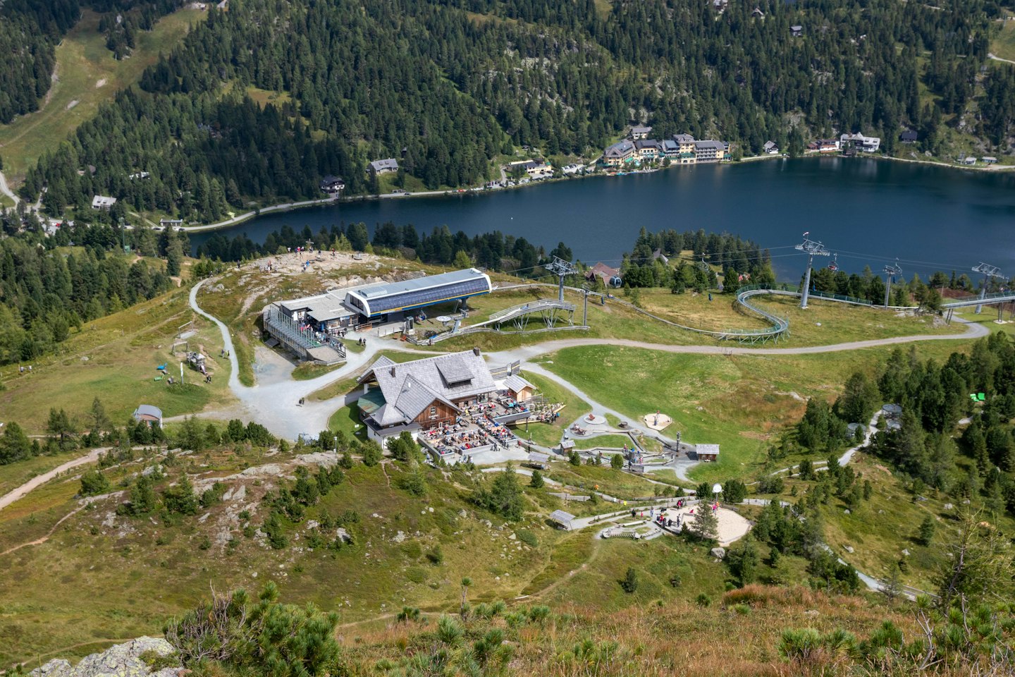 Mountain resort with a restaurant, chairlift, and alpine coaster.
